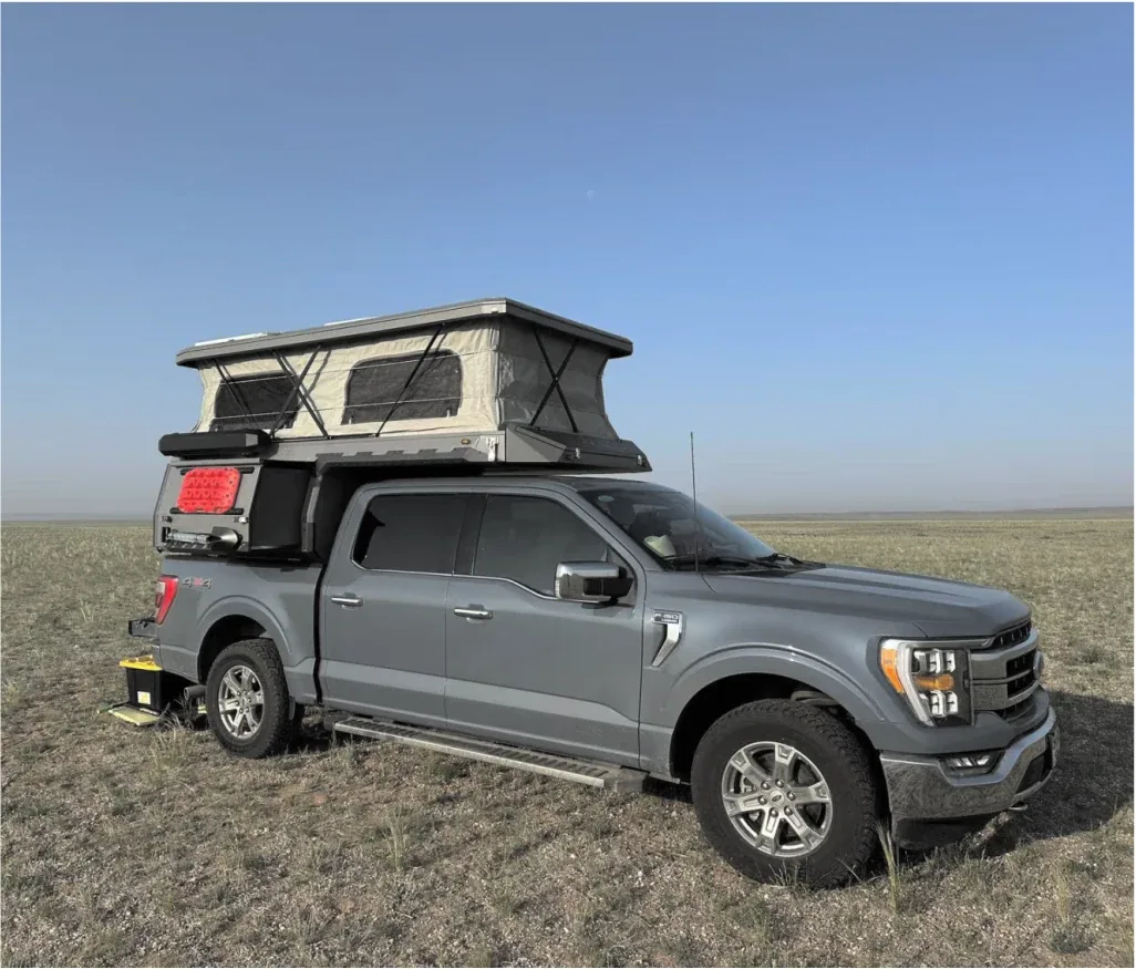 Pickup truck fitted with a TUYU pop-top camper in open steppe country