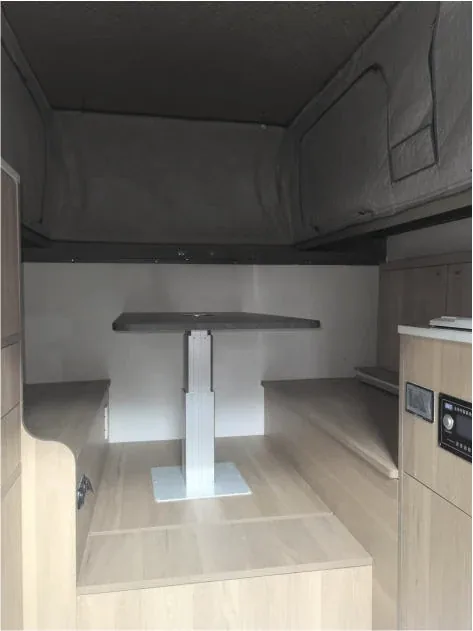 Camper interior lounge area with seating and table